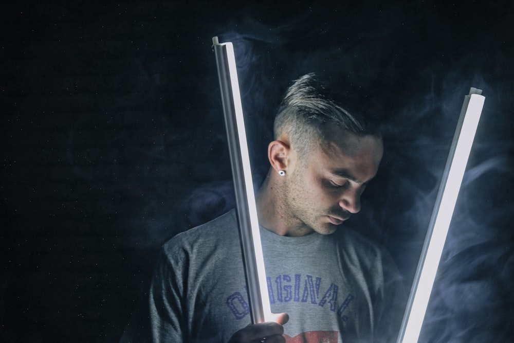 man holding fluorescent lamps