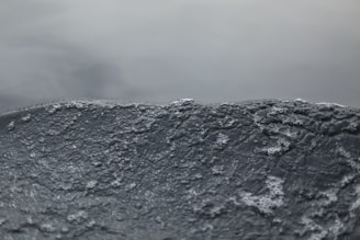 A smooth liquid animation background with subtle light reflections in dark mode.