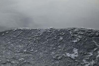 A smooth liquid animation background with subtle light reflections in dark mode.