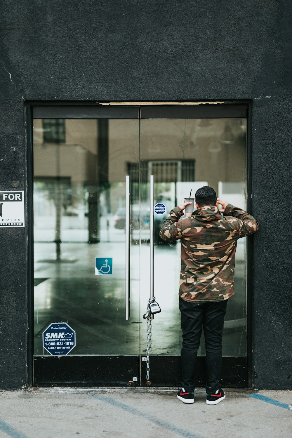 man facing at the glass door