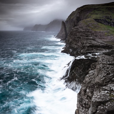 waves crashing sea cliffs digital wallpaper