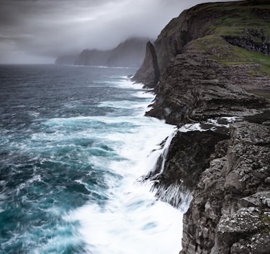 waves crashing sea cliffs digital wallpaper
