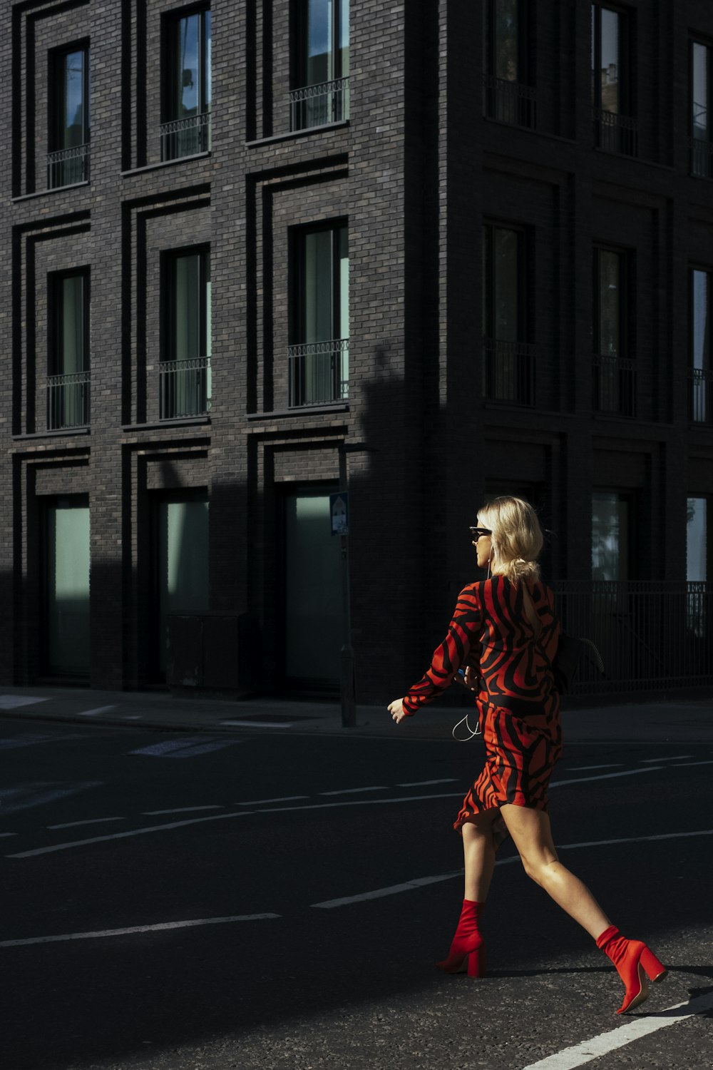 woman crossing the street during daytime