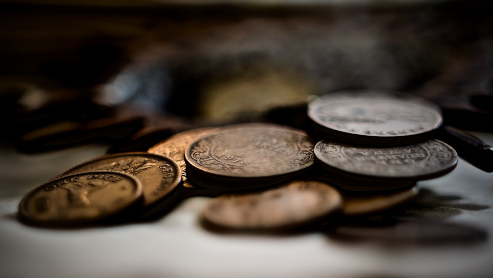 selective focus photography of coins on white surface