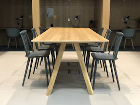 A modern, clean workspace with custom wooden furniture and precise craftsmanship details.