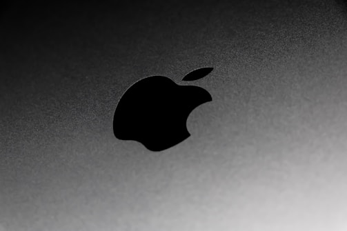 Close-up of sleek metallic tech components with dark gray gradients.