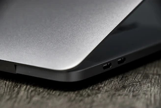 Close-up of a sleek laptop displaying a detailed product review page with ratings and images.