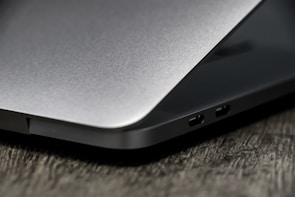 Close-up of a sleek laptop on a wooden desk ready for sale.