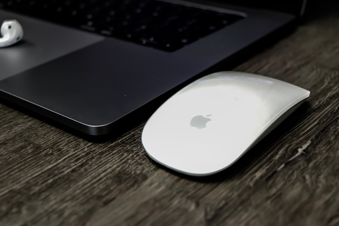 white Apple Magic Mouse on table