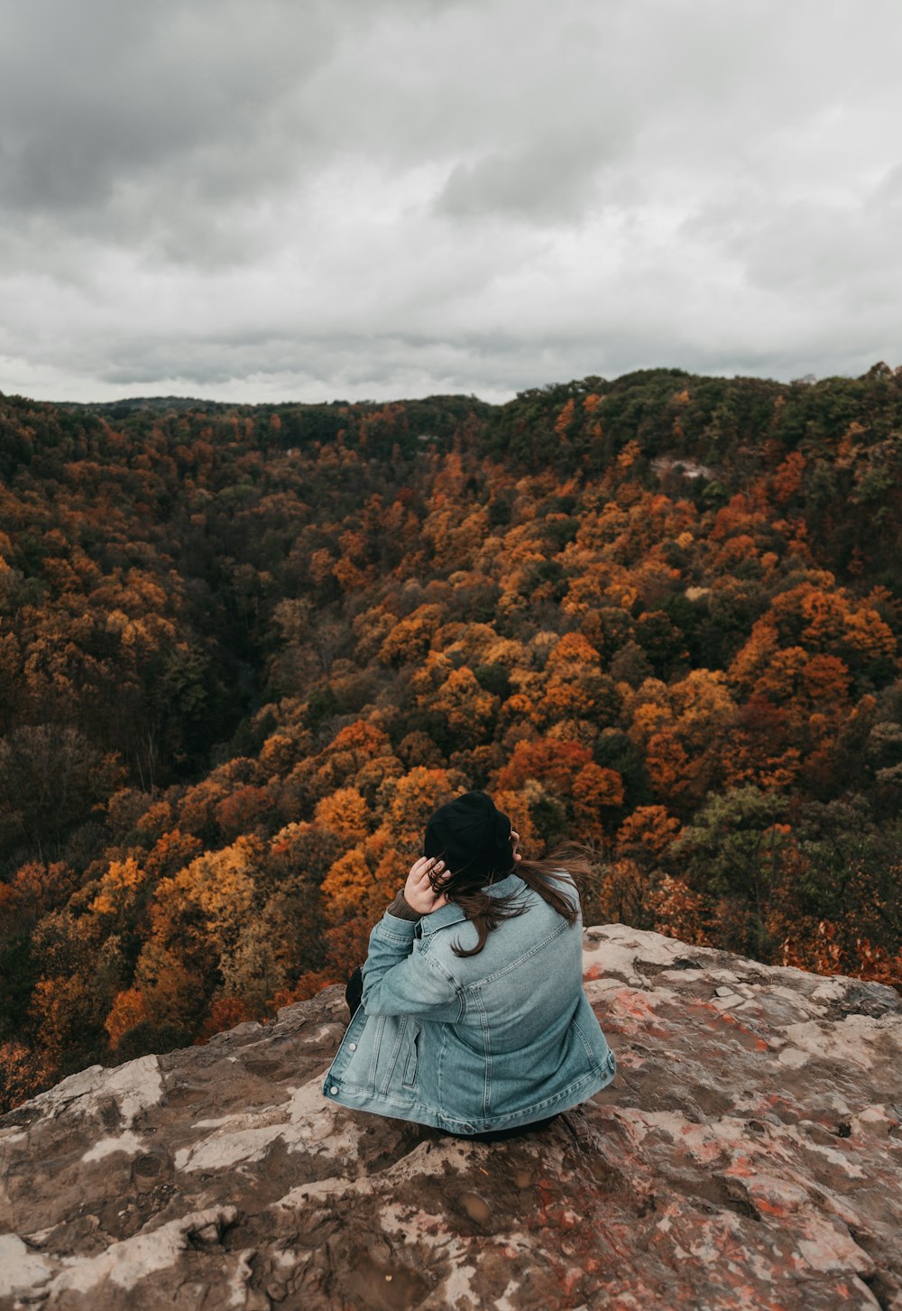 woman sitting on rock formation