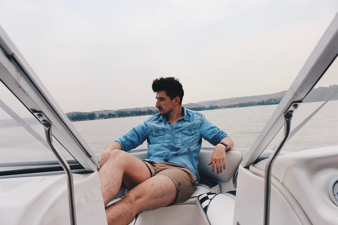 man sitting on speedboat