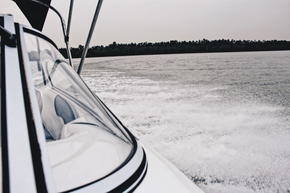 white cruiser boat on body of water during daytime