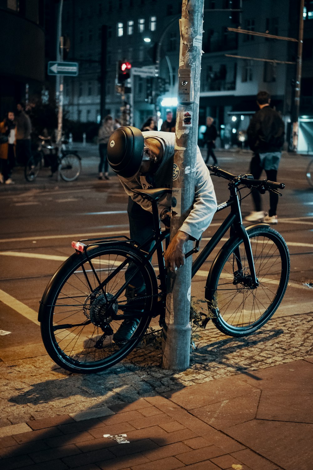 man standing beside bicycle