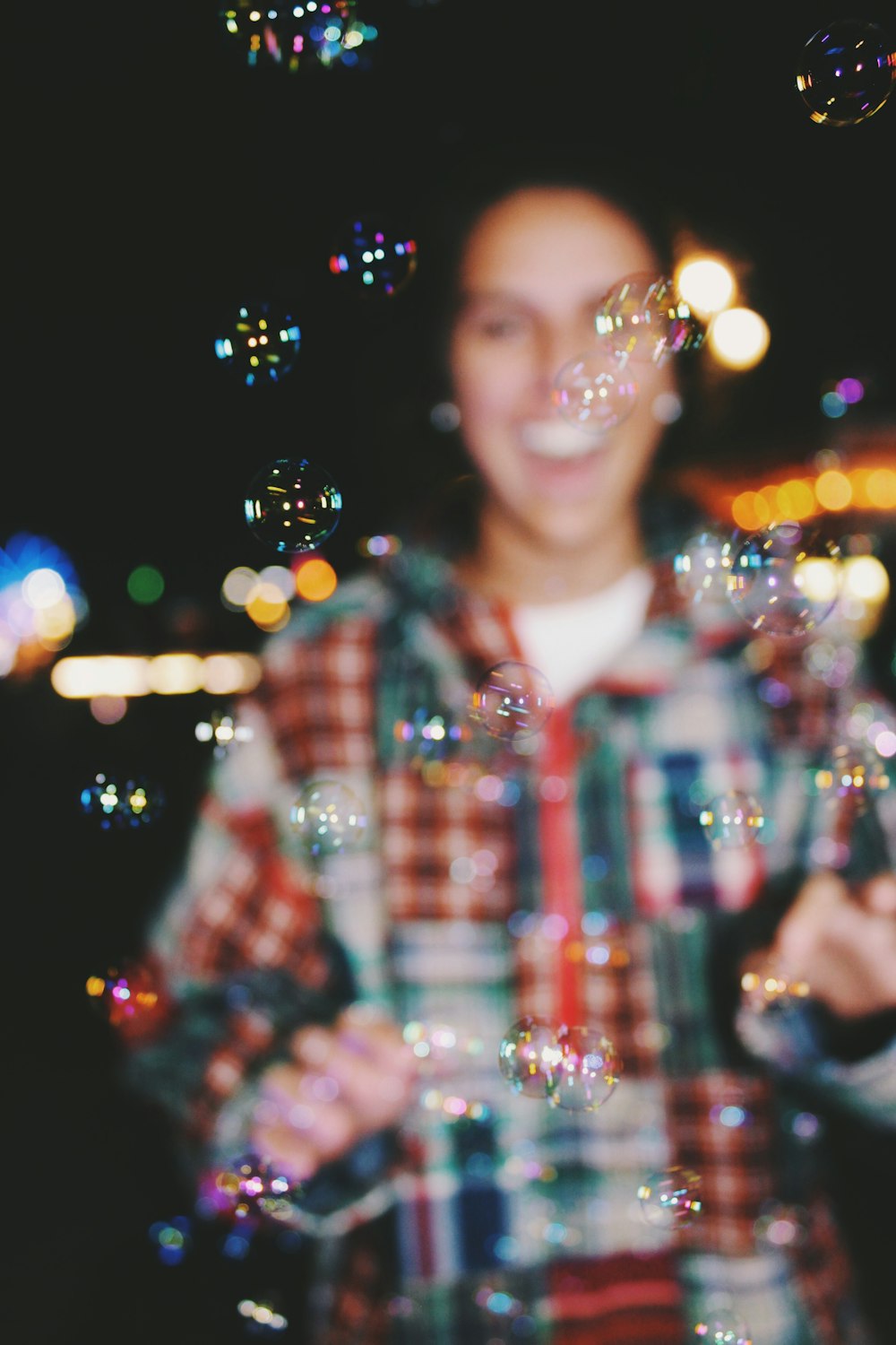 a man standing in front of a bunch of bubbles