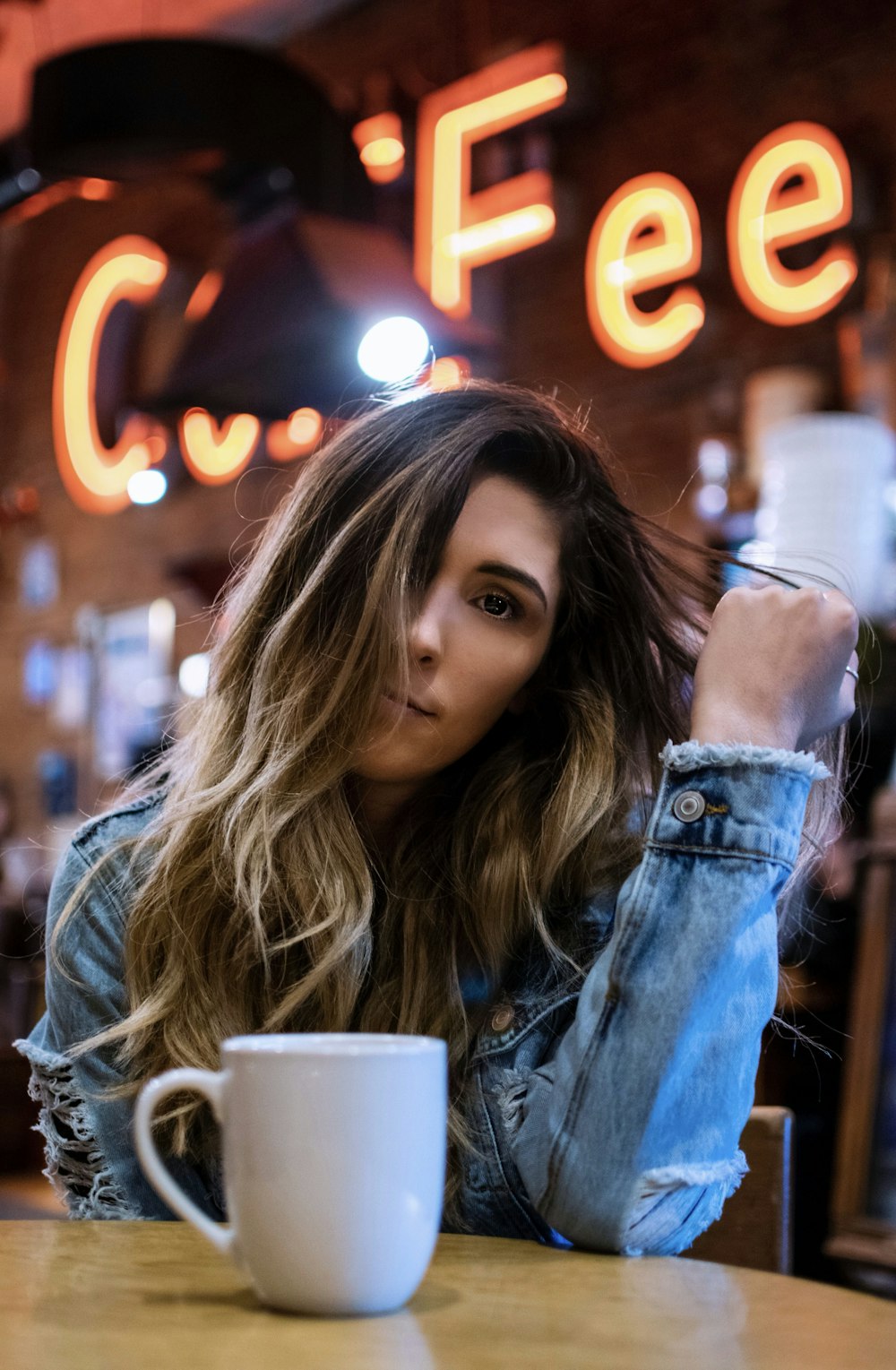 woman sitting on chair inside cafe