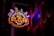 A vibrant neon sign with the words 'HY CLUB' in bold letters is featured prominently. It includes musical notes and a guitar graphic, suggesting a music-themed venue. The sign glows in bright colors against a dark background, with architectural elements visible beside it, further enhancing the urban nightlife ambiance.