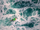 high-angle photography of man riding on surfboard