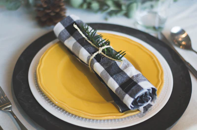 Close-up of yellow-themed table setting with black and white accents.