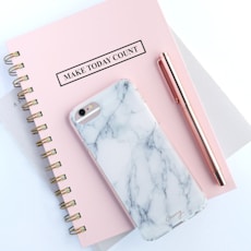 rose gold iPhone 6s and white and gray marble case