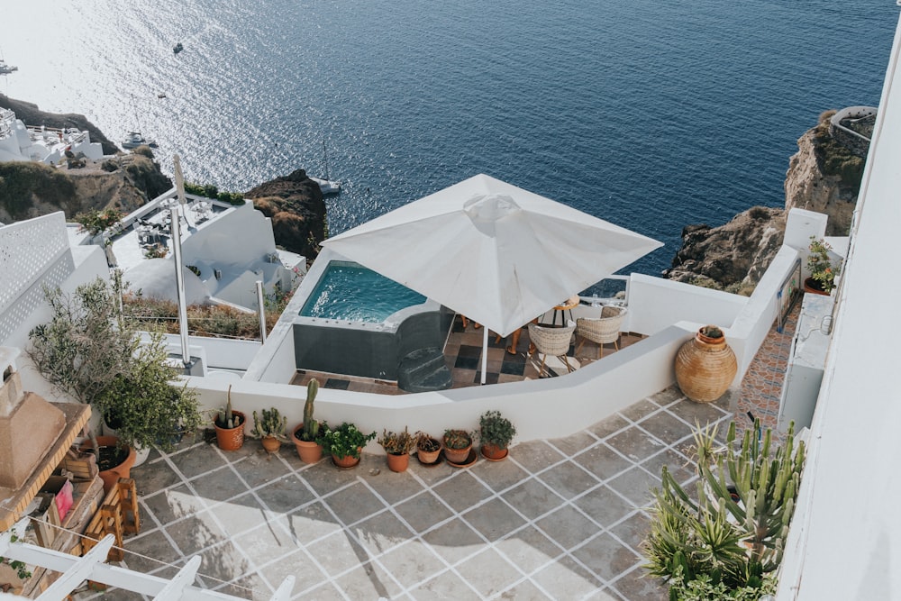 an aerial view of a house with a pool and an umbrella