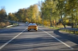 A scenic view of a road with a taxi driving through.