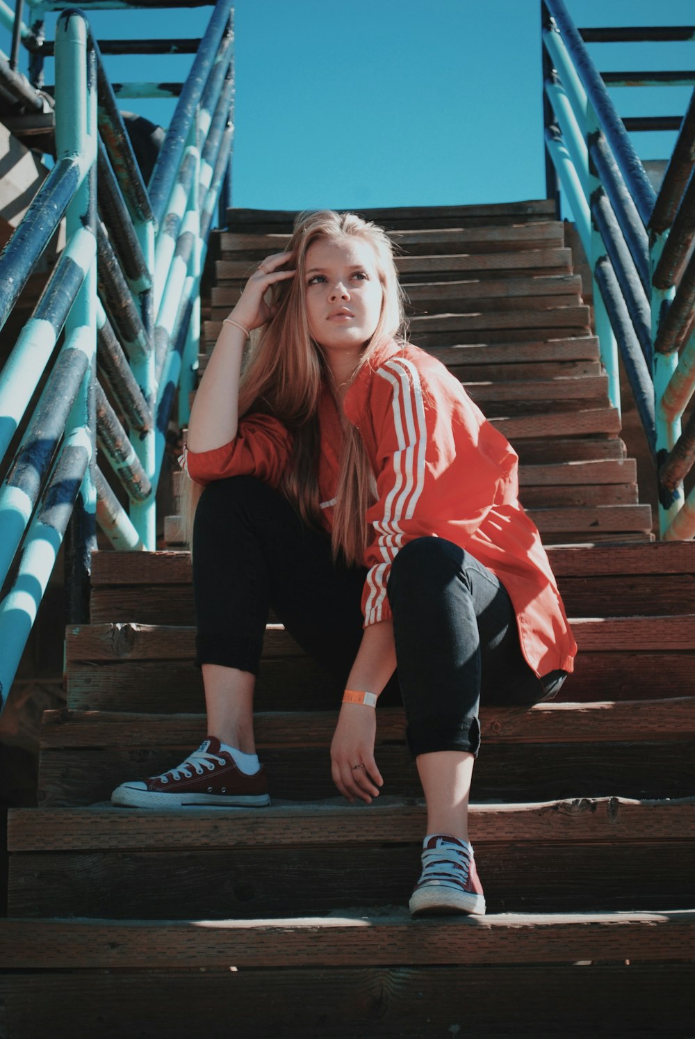 woman sitting on stair outdoors during daytime