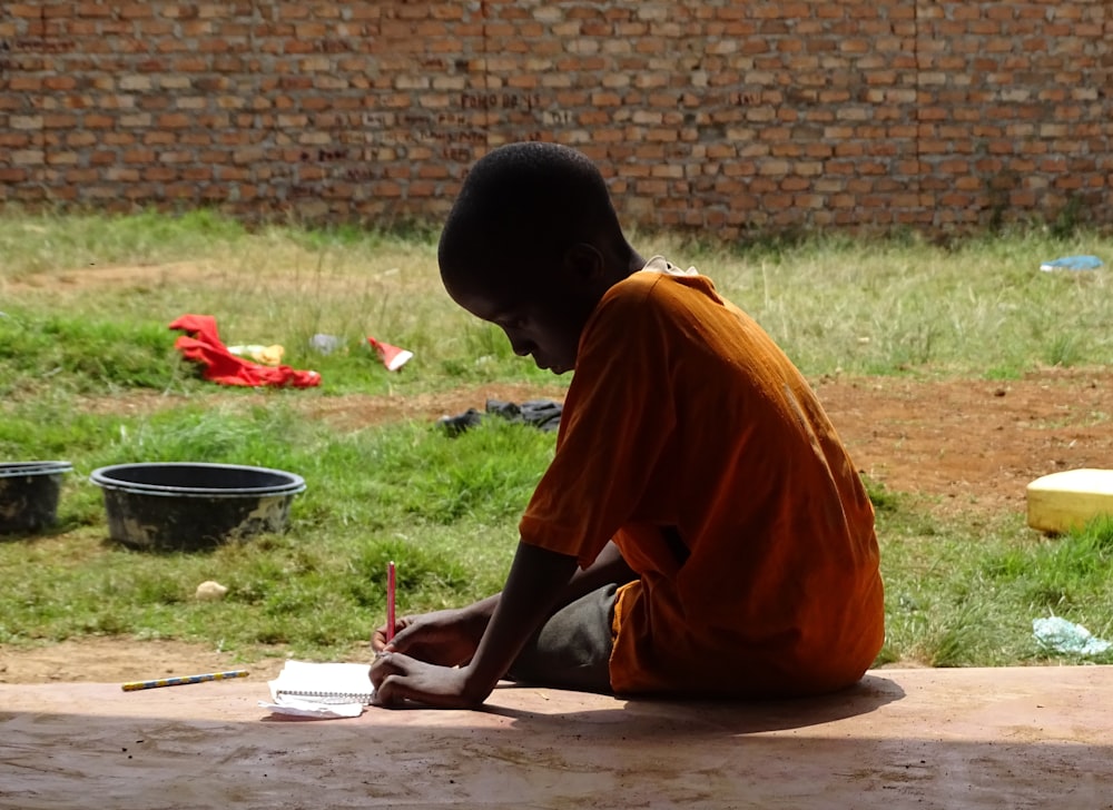 boy writing on notepad