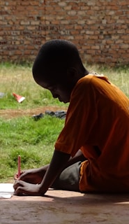 boy writing on notepad