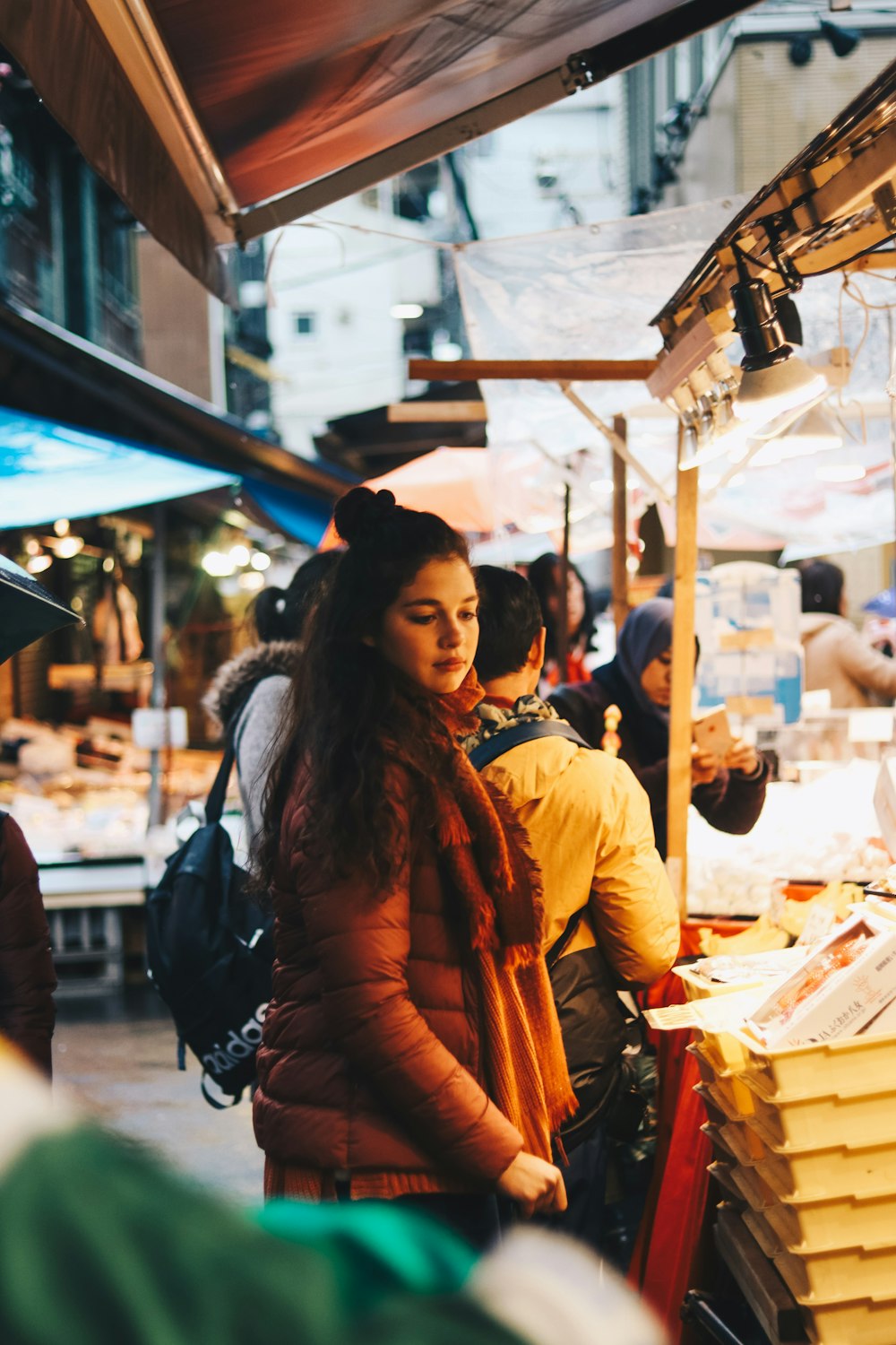 woman standing in front of stall