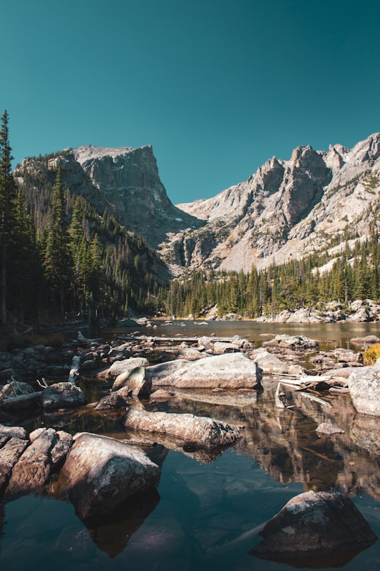 river beside mountain during daytime in Rocky Mountain National Park United States