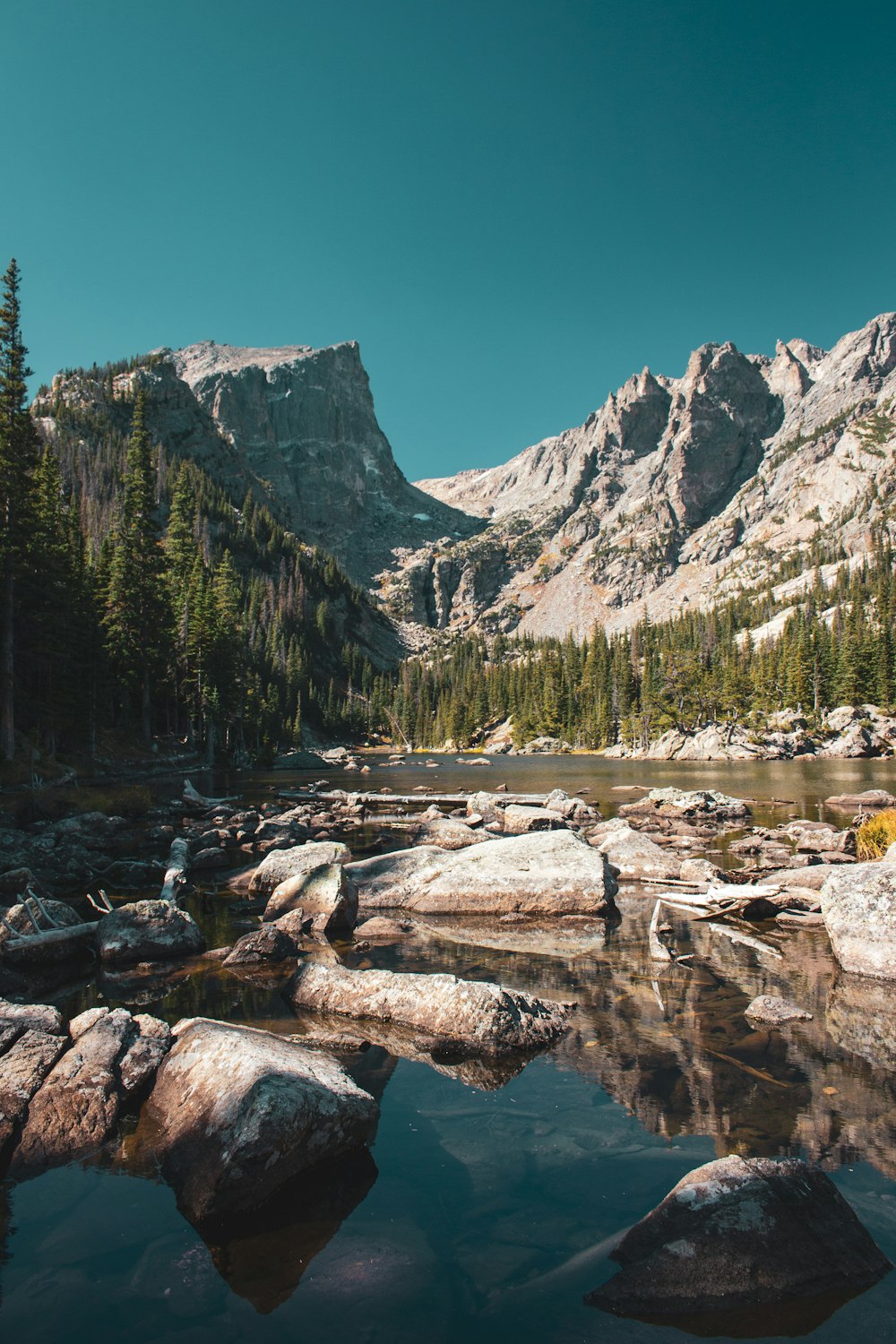 river beside mountain during daytime