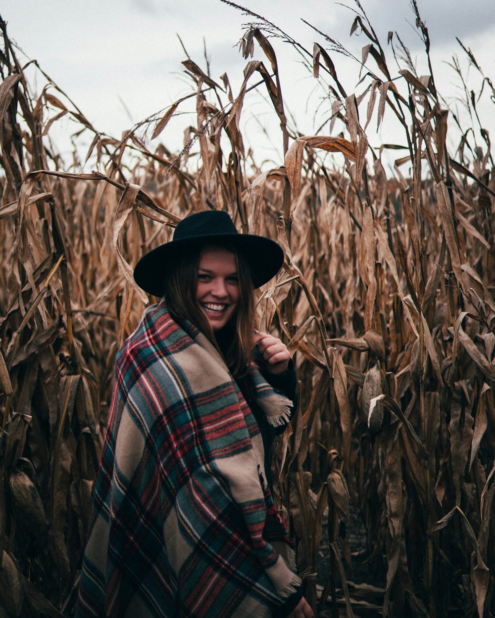 woman smiling in the middle of a wheat field