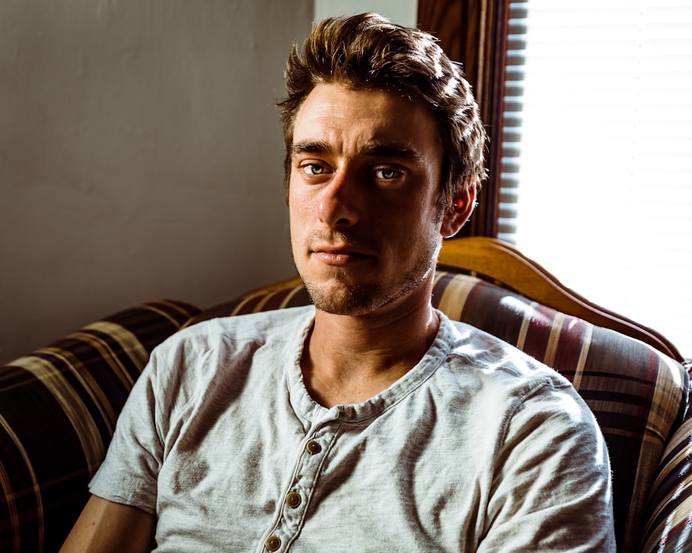 man sitting on sofa in room