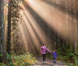 woman walking in forest with child