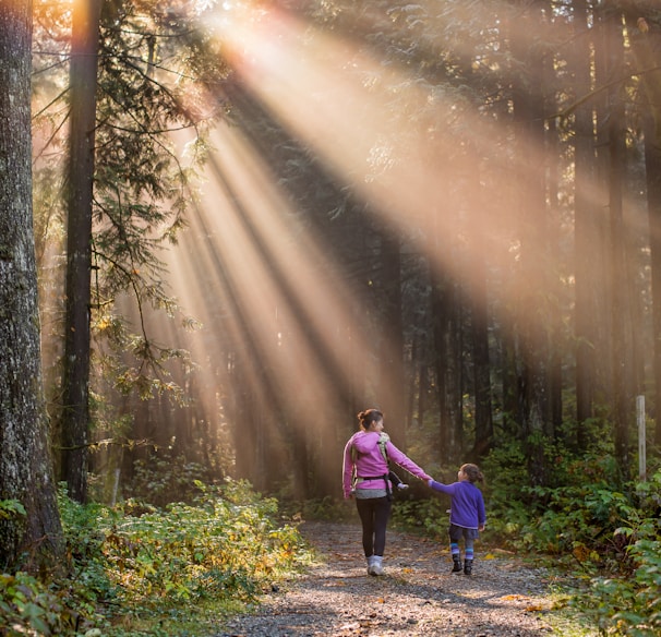 woman walking in forest with child