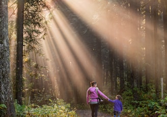 woman walking in forest with child