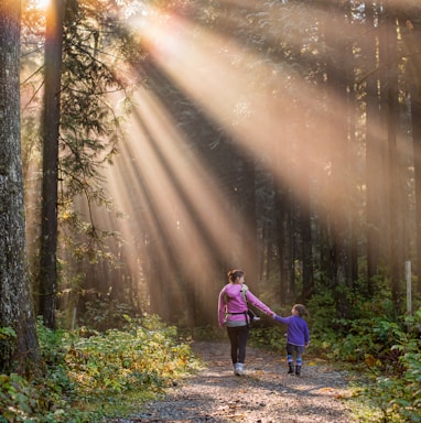 woman walking in forest with child