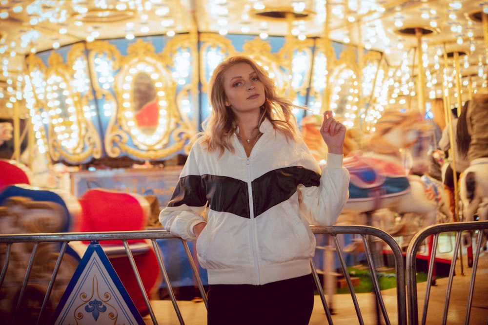 woman standing near carousel