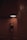 A dancer in a dark leotard gracefully stretches upward, reaching toward a bright circular light on the ceiling. The setting features warm, textured walls with a word 'Southbound' visible on one side.