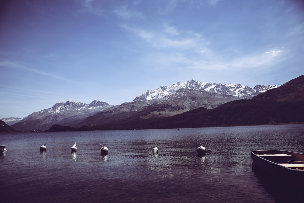 a group of boats floating on top of a lake