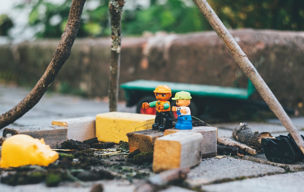 two lego toys on wooden bricks close-up photography