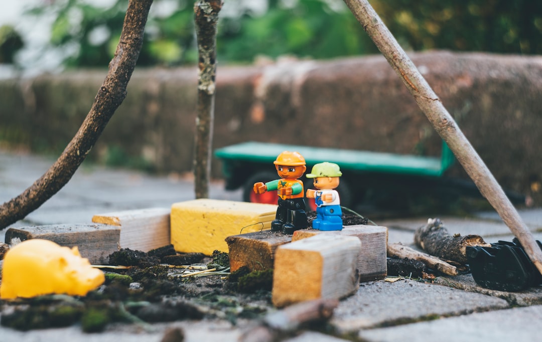 two lego toys on wooden bricks close-up photography