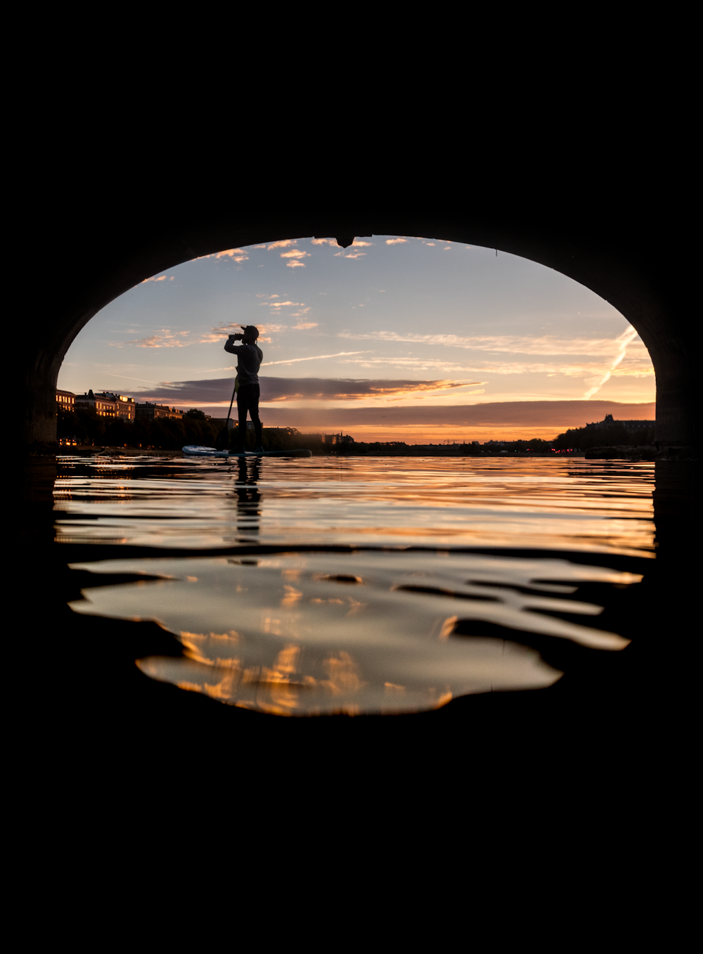 silhouette of person standing near body of water