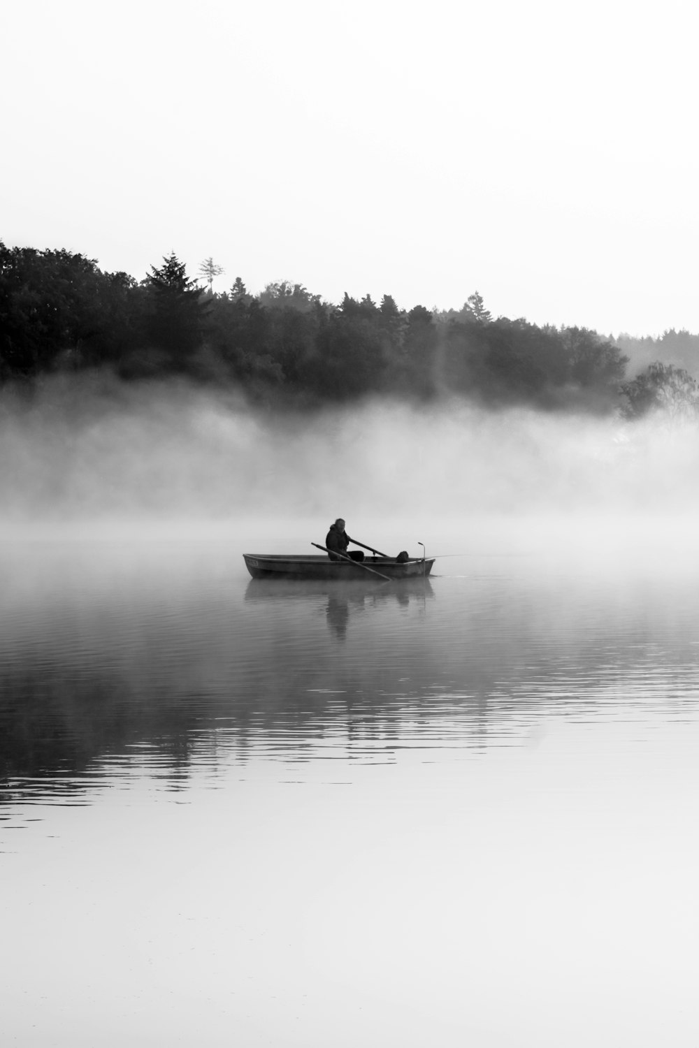 man riding on boat grayscale photo