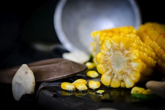 Corn flour in a bowl with corn kernels.