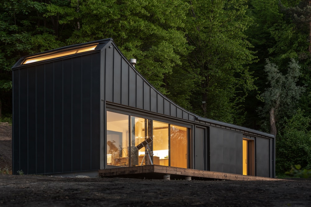 black metal trailer house near green trees