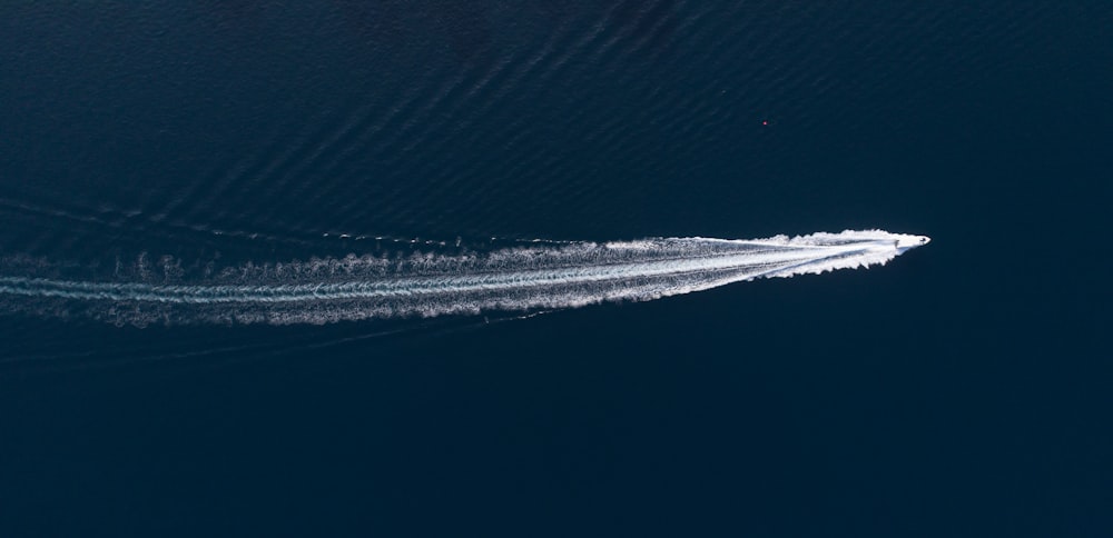 white speedboat made a track on water