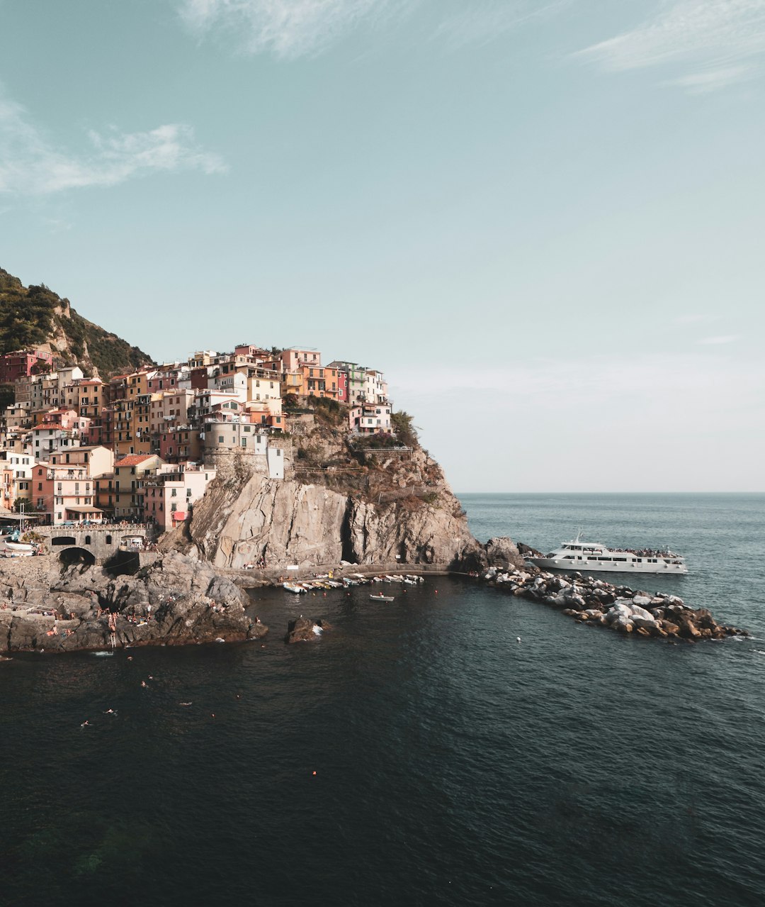 ship docked beside cliff