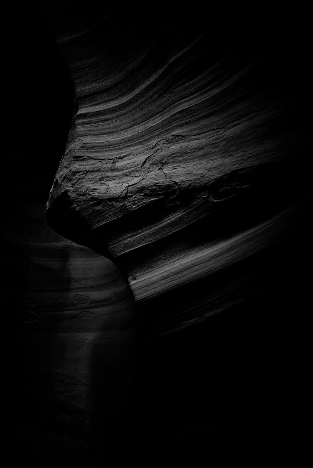 a black and white photo of a rock formation