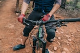 a man riding a bike down a dirt road